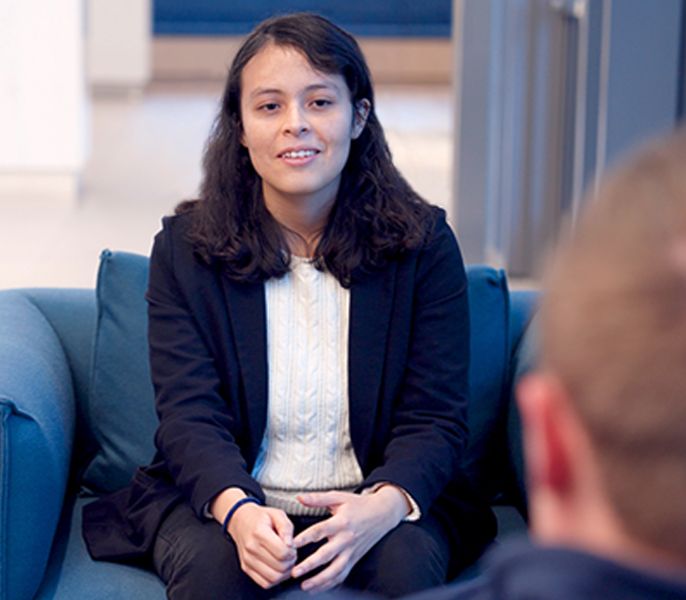 Spectrum Scholar Yuri Jiminez speaks with her mentor during the 2023 Spectrum Scholars Summit 