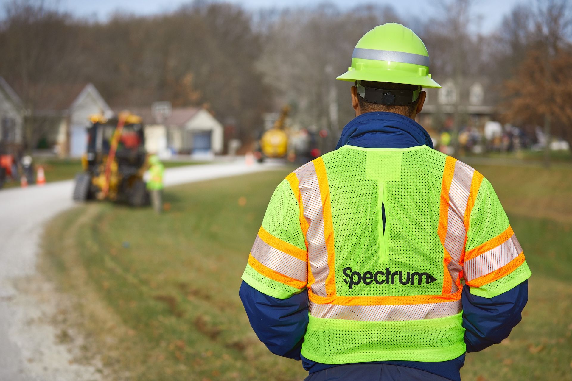 A Spectrum field technician observes a plow burying conduit during a broadband expansion project