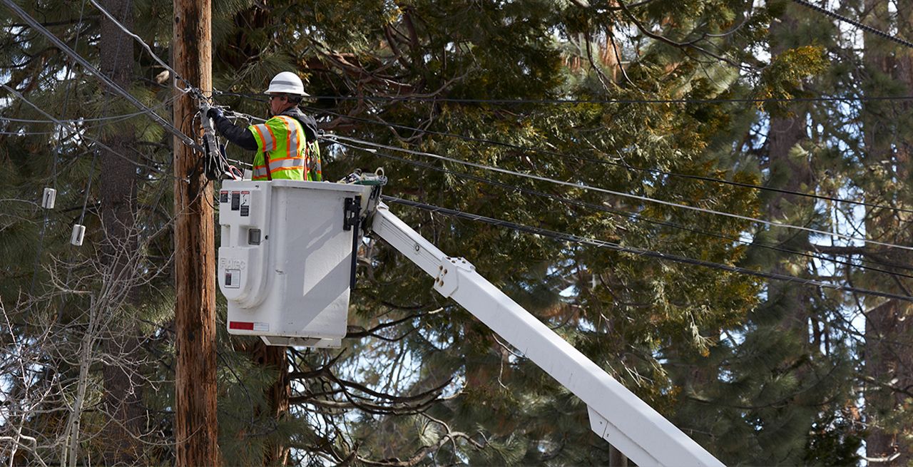 Spectrum technician working in a bucket on a broadband expansion project